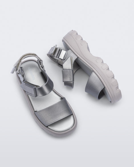 Top and side view of a pair of silver kids Kick Off Sandals