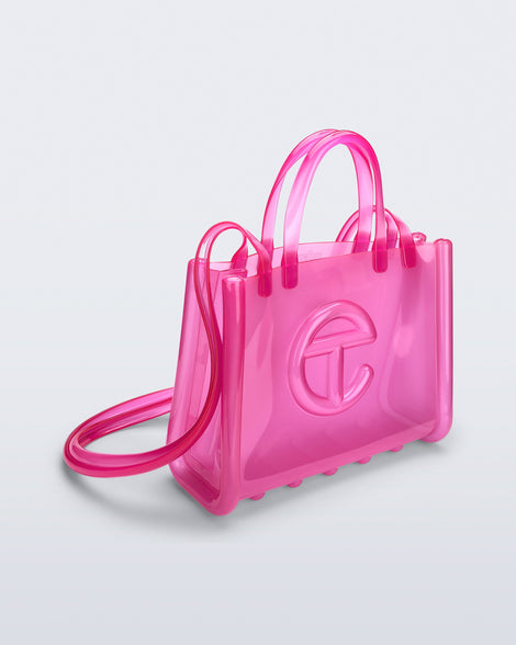 Angled view of the pink Medium Jelly Shopper x Telfar bag