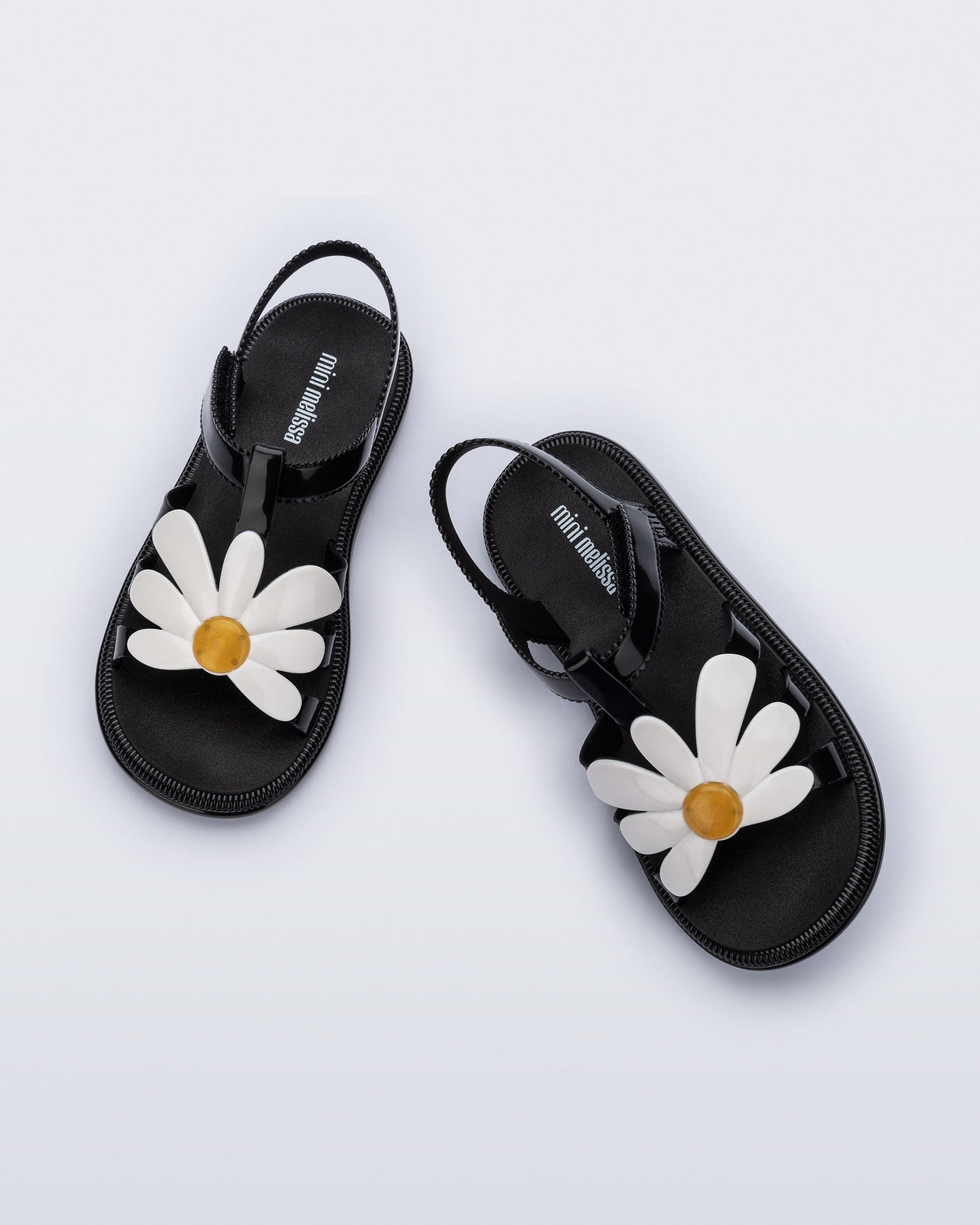 Top view of a pair of black and white kids Hip Bloomy sandal.