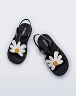 Top view of a pair of black and white kids Hip Bloomy sandal.