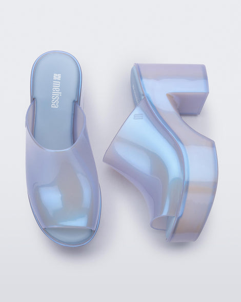 Top and side view of a pair of pearly blue Mule Hype heel platforms