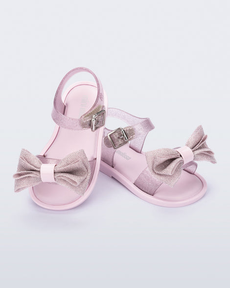 Angled view of a pair of glitter pink Mar Sweet baby sandals