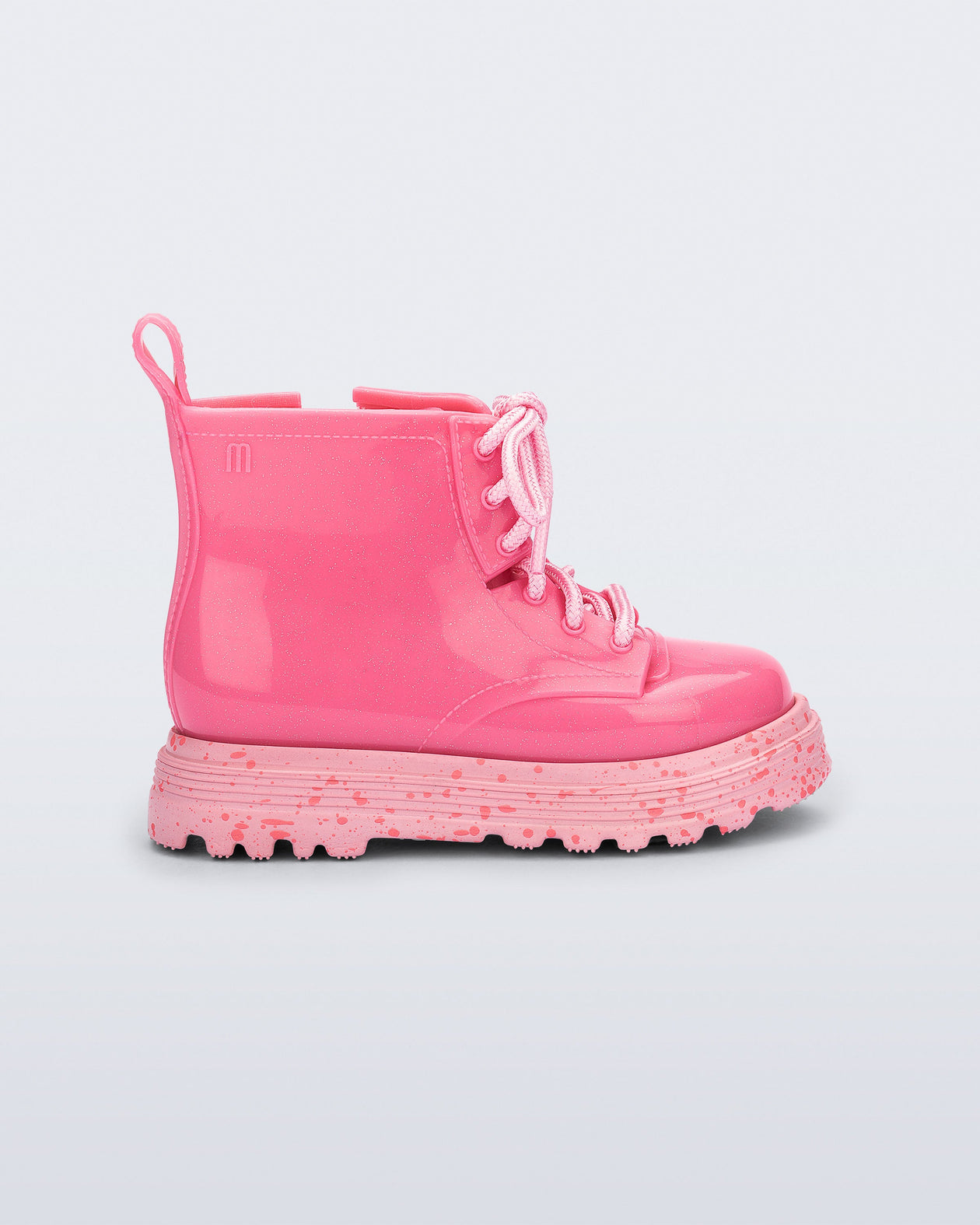 Side view of a pink Coturno baby boot with pink laces.