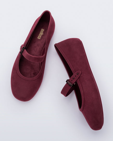 Side and top view of a pair of burgundy red Soft Ballerina Velvet flats