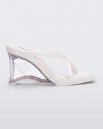 Side view of a white Glass Heel with a heart cutout in the heel.