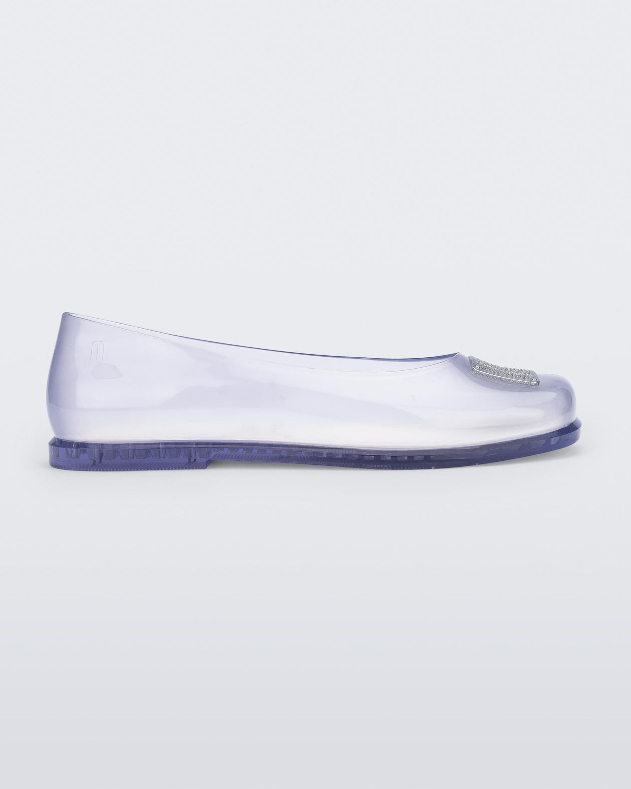 Side view of a clear Ruby + Marc Jacobs flat