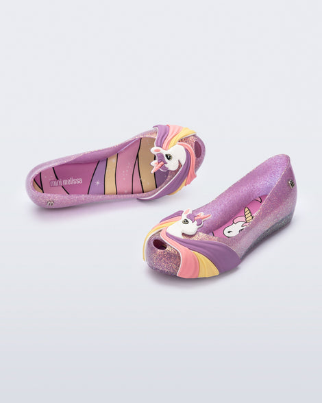 Angled view of a glitter lilac kids Ultragirl Unicorn with a unicorn with a rainbow mane on the upper toe area