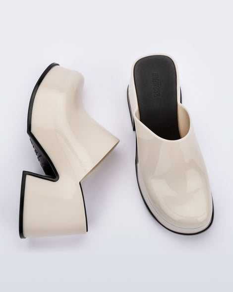 Top and side angled view of a pair of beige Mia Platform Mule Heels with black sole