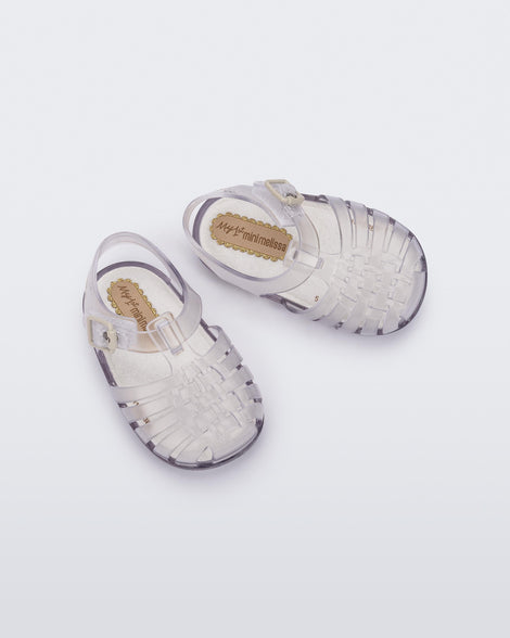 Top angled view of a pair of clear baby My First Mini Melissa Possession sandals.