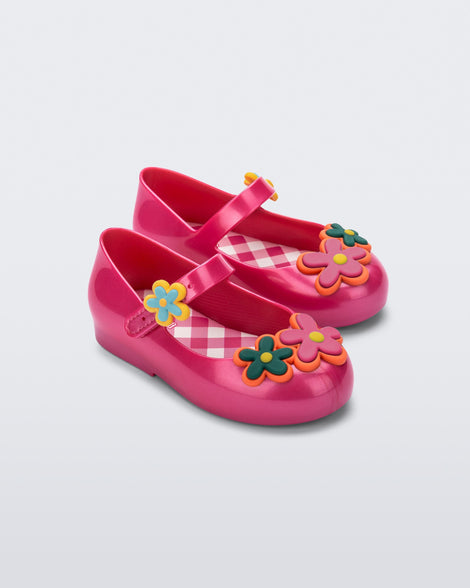 Angled view of a pair of pink Sweet Love Picnic baby flats with flowers