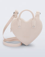 Front view of a beige Heartbeat bag with small handles and longer strap.