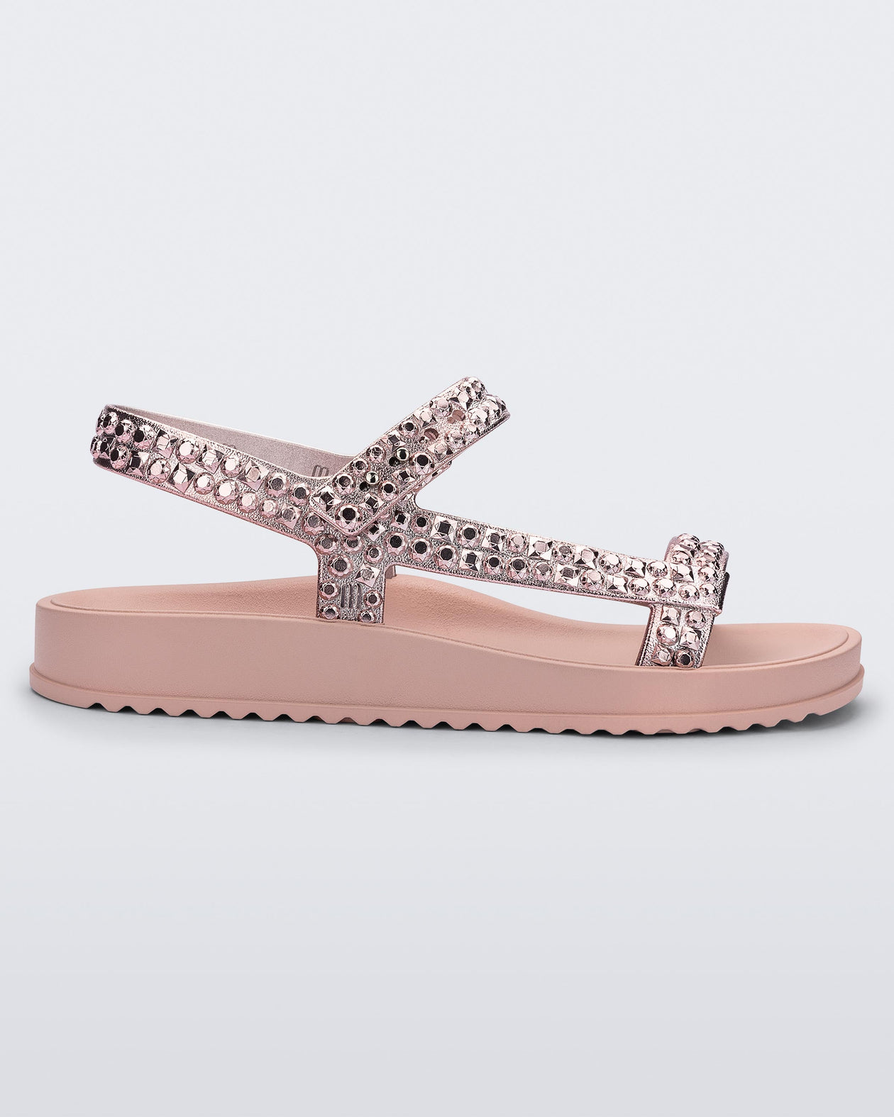 Side view of a pink Lust sandal with rose gold strap