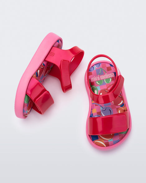 Top and side view of a pair of pearly red baby Jump sandals