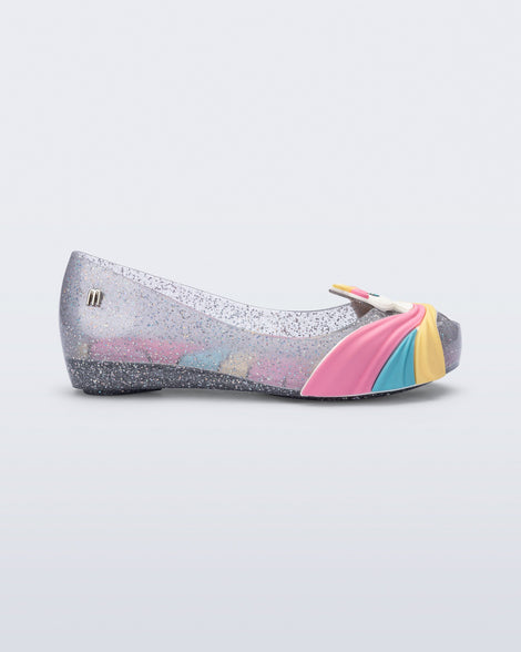 Side view of a glitter clear/pink  kids Ultragirl Unicorn flat