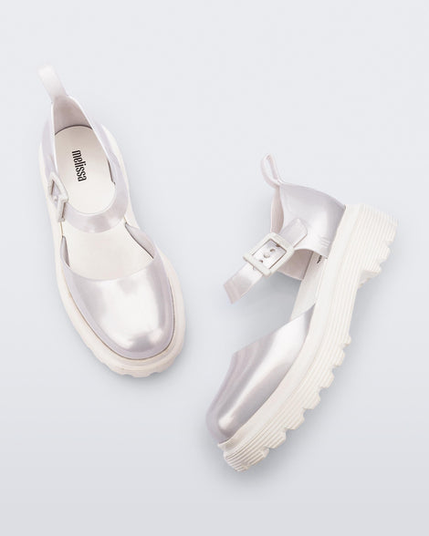 Side and top view of a pair pearly white Ellie ankle strap loafers