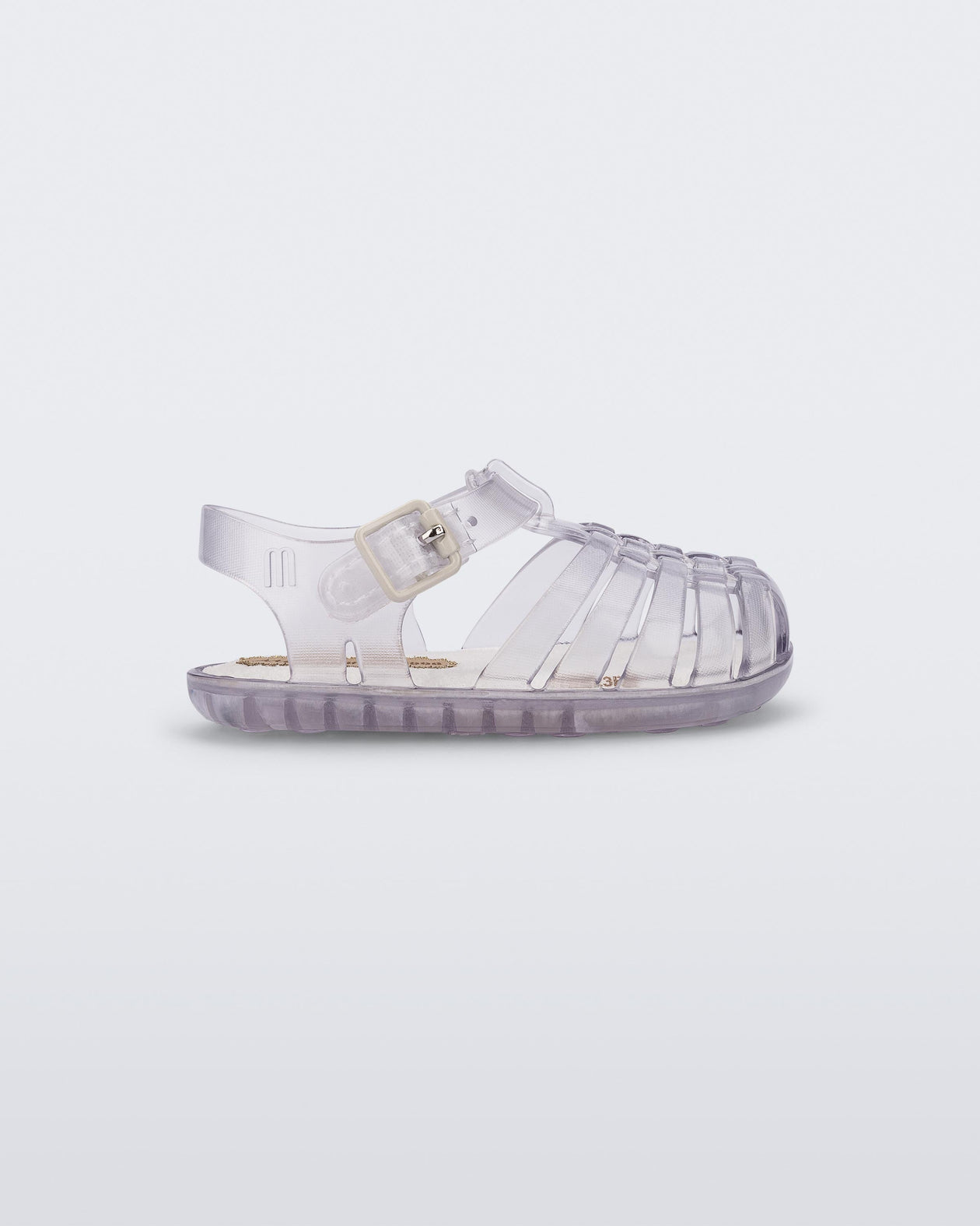 Side view of a clear baby My First Mini Melissa Possession sandal