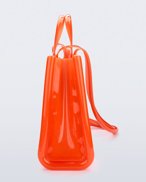 Side view of the orange Large Jelly Shopper x Telfar bag