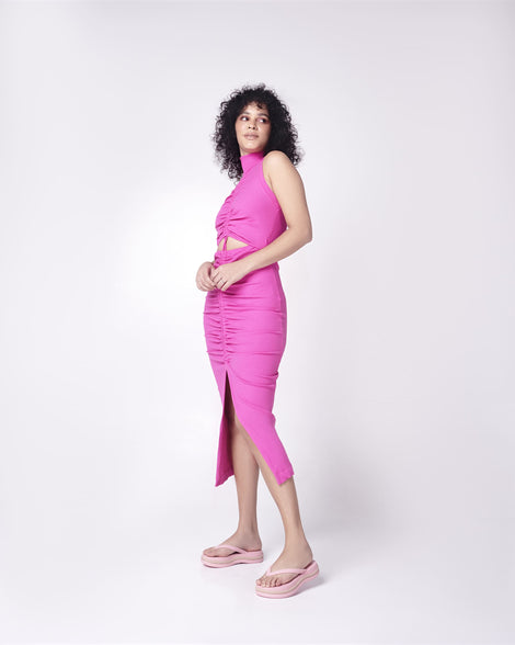 A model posing for a picture in a pink dress, wearing a pair of pink/beige Melissa Leblon platform flip flops with details that mimic sisal braids on the sole and strap