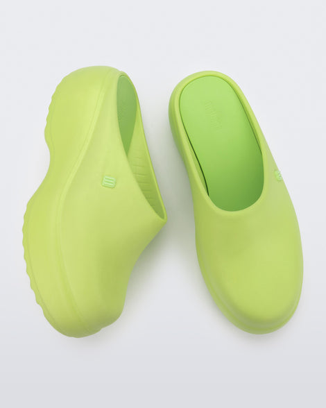 Side and top view of a pair of green Free Clog Platforms