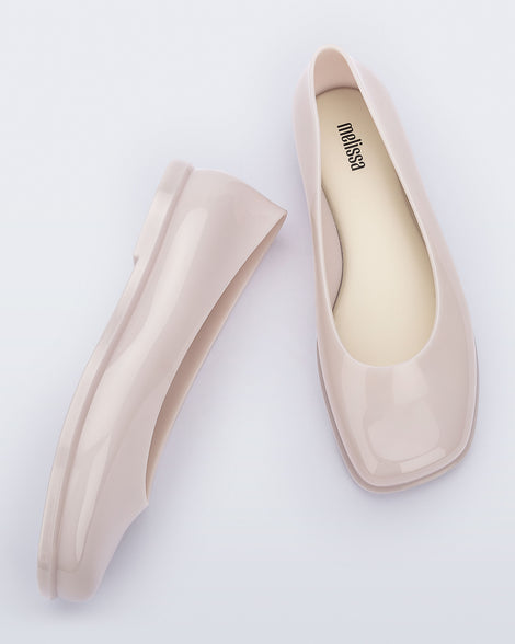 Side and top view of a pair of beige Ruby adult flats.