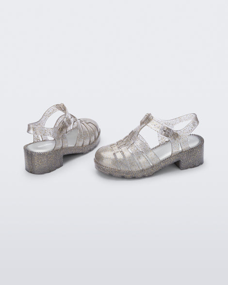 Back and side view of a pair of clear glitter gold kids Possession Heel sandals