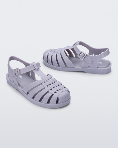 Side angled view of a pair of grey Possession sandals