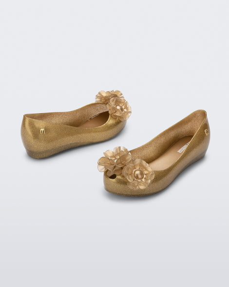 Angled view of a pair of glitter beige kids Ultragirl Springtime flats