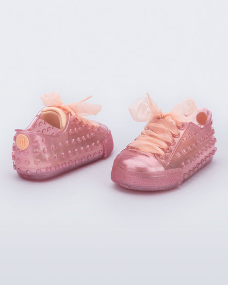 Back and angled view of a pair of pearly pink Polibolha baby sneakers with laces.