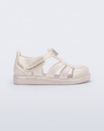 Side view of a metallic beige baby Hip Daydream sandal