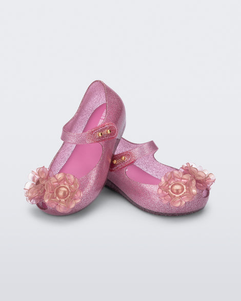 Angled view of a pair of glitter pink baby Ultragirl Springtime flats