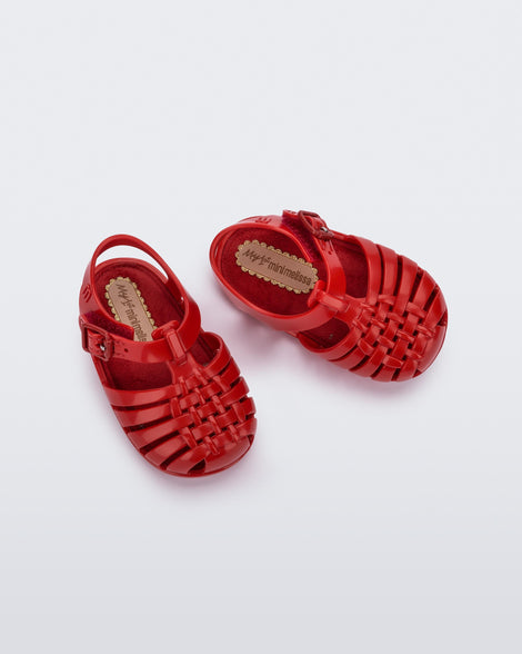 Top angled view of a pair of red baby My First Mini Melissa Possession sandals.