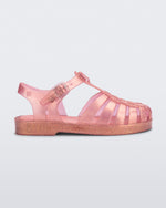 Side view of a pearly pink kids Possession sandal