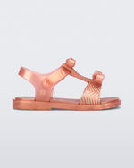 Side view of a pink baby Dream Sandal with two bows and gold detail on strap