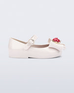 Side view of a white Sweet Love Snow White baby flat with a white bow with red apple center