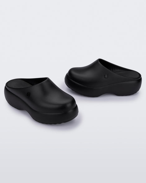 Side and angled view of a pair of black Free Clog Platforms