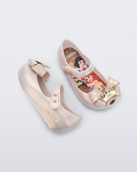 Angled and side view of a pair of metallic beige baby Ultragirl Princess flats