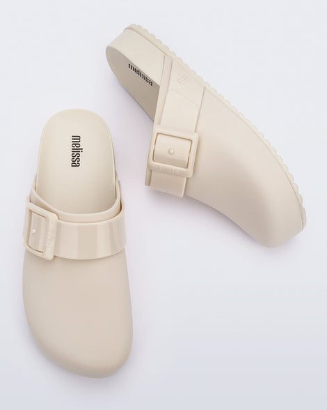 Top and side view of a pair of beige adult Cozy Clog.