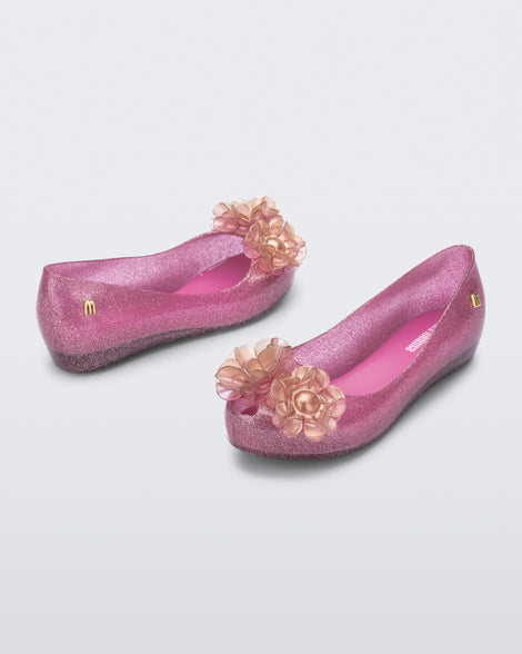 Angled view of a pair of glitter pink kids Ultragirl Springtime flats