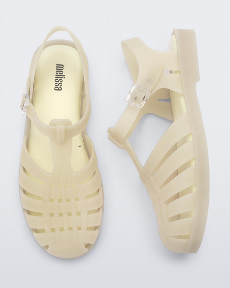 Side and top view of a pair of light beige Possession sandals