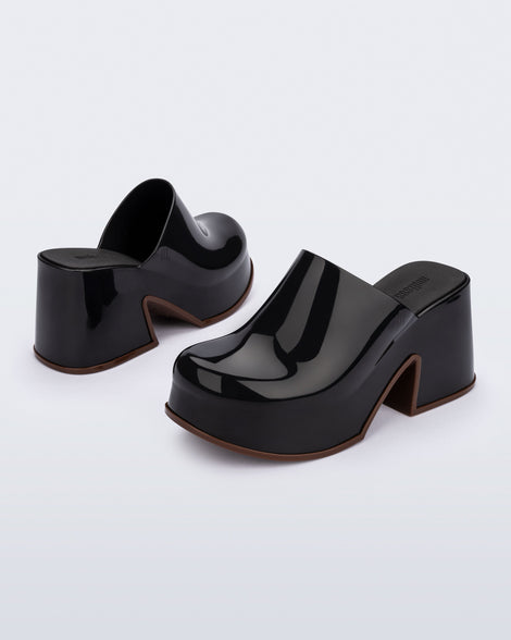 Back and front angled view of a pair of black Mia Platform Mule Heels with brown sole