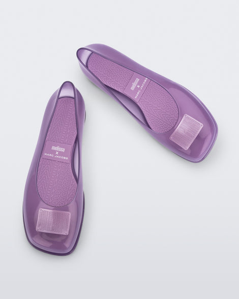 Top and angled view of a pair of lilac Ruby + Marc Jacobs flats