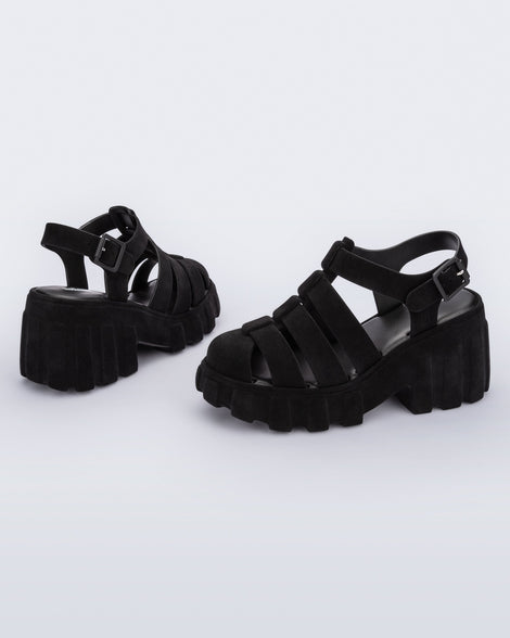 Back and side view of a pair of black Megan Velvet heel sandals.