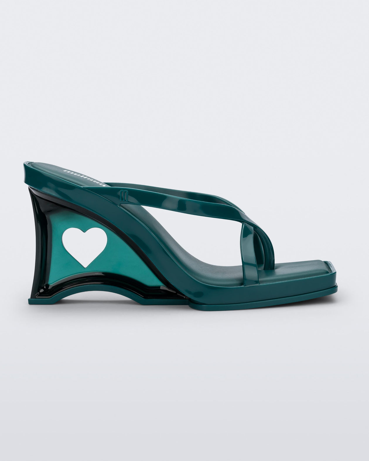 Side view of a green Glass Heel with a heart cutout in the heel.