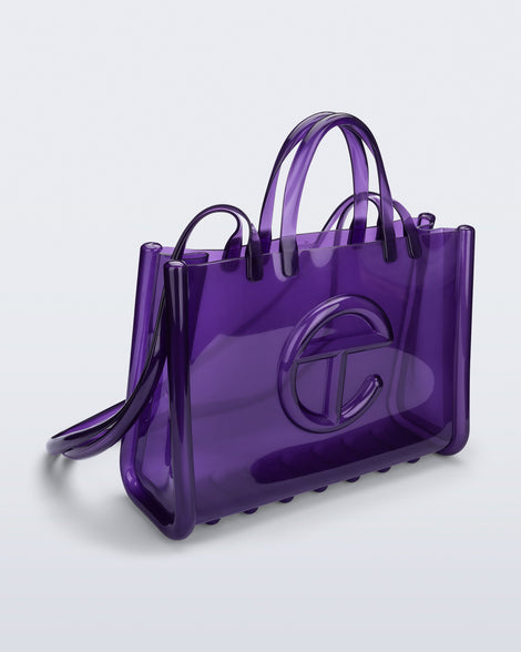 Angled view of the purple Large Jelly Shopper x Telfar bag