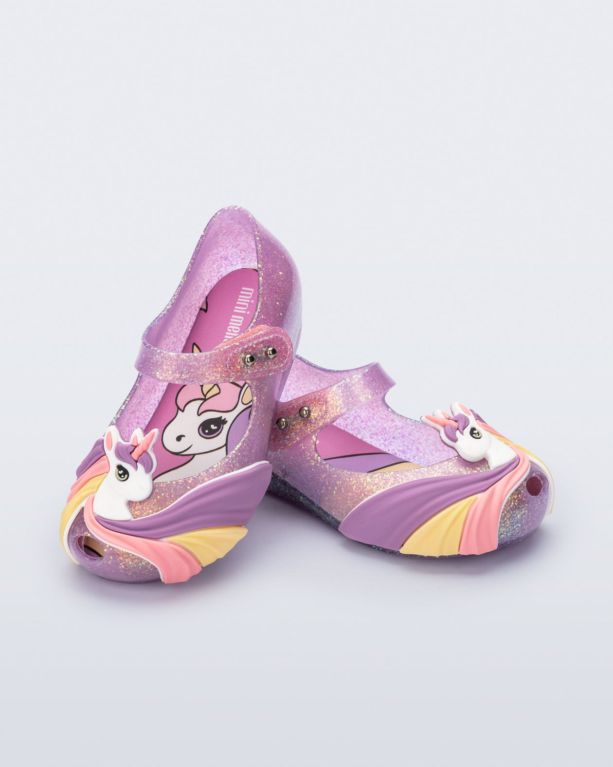 Angled view of a glitter lilac baby Ultragirl Unicorn with a unicorn with a rainbow mane on the upper toe area