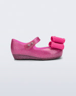 Side view of a glitter pink baby Ultragirl Classic Bow flats