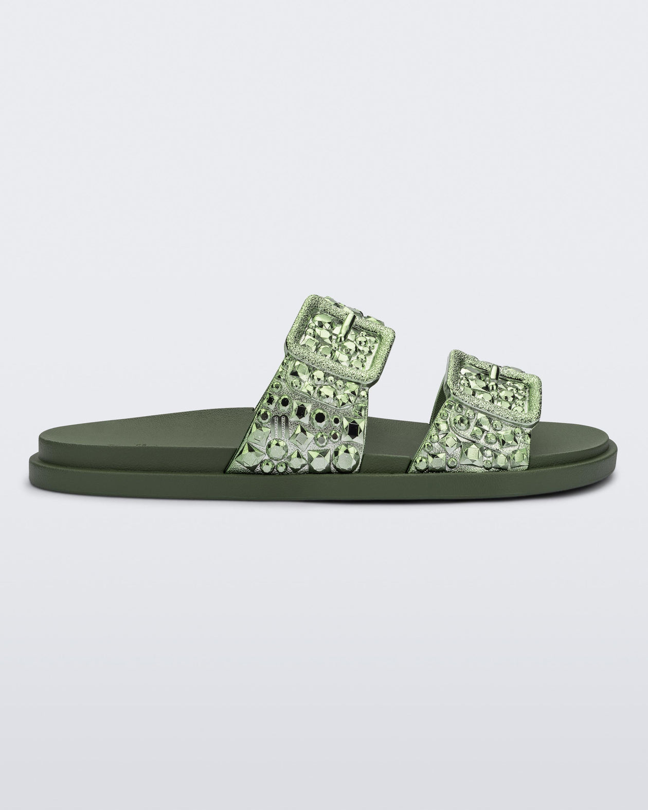 Side view of a green Lust Slide with metallic buckle straps