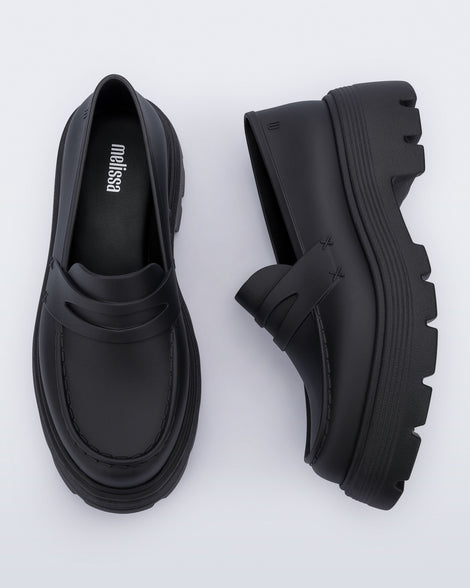 Top and side view of a pair of matte black Royal adult loafers