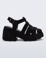 Side view of a black Megan Velvet heel sandal.