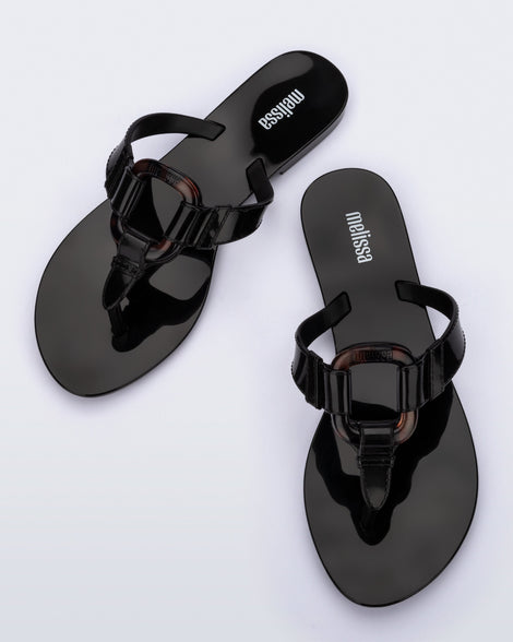 Top view of a pair of black Olivia adult flip flops